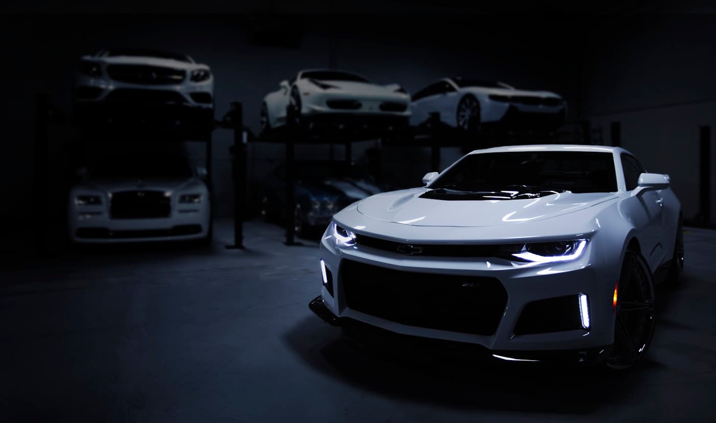A performance car in a dimly lit garage and workshop