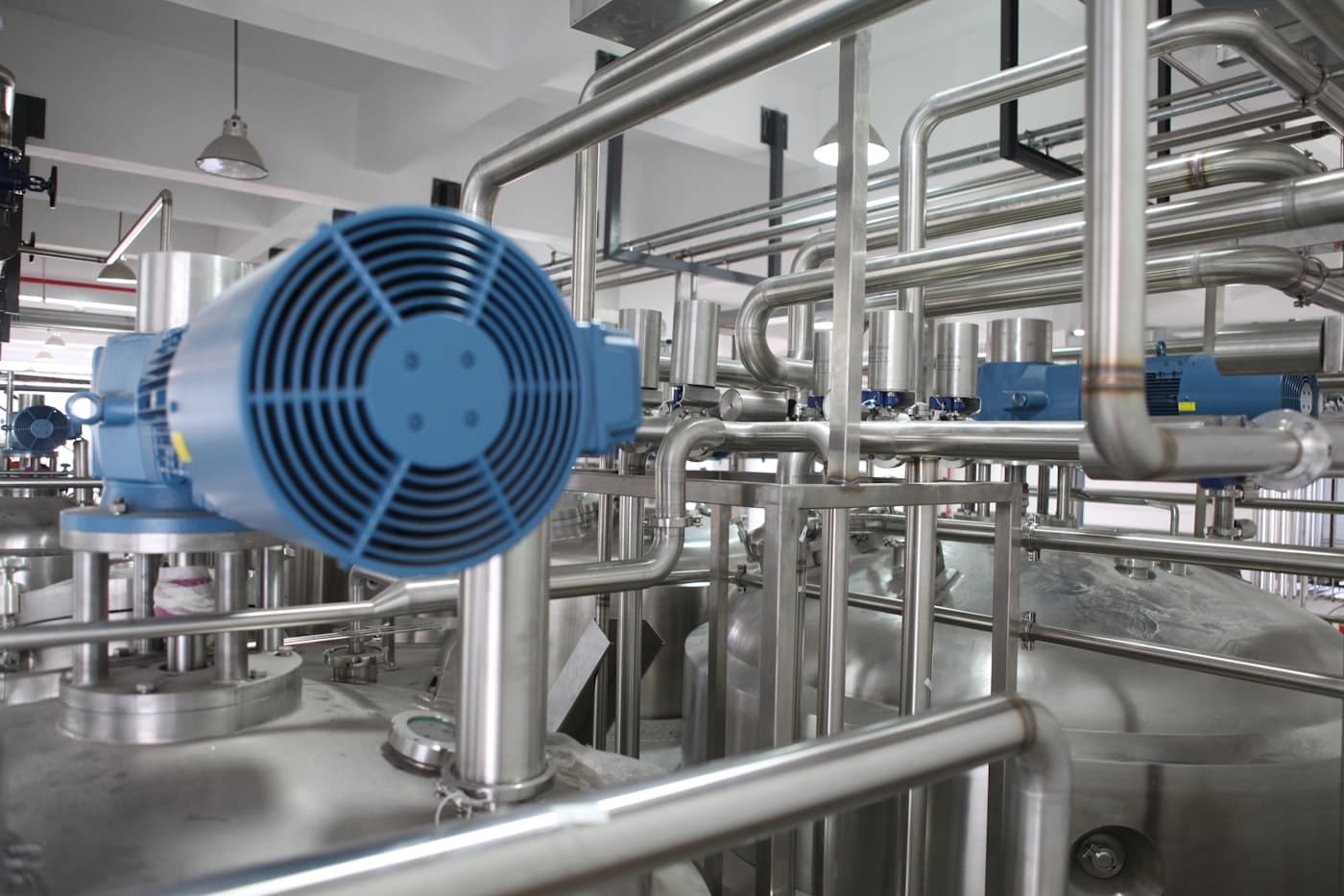 Steel pipes, pumps and industrial machinery in a manufacturing plant